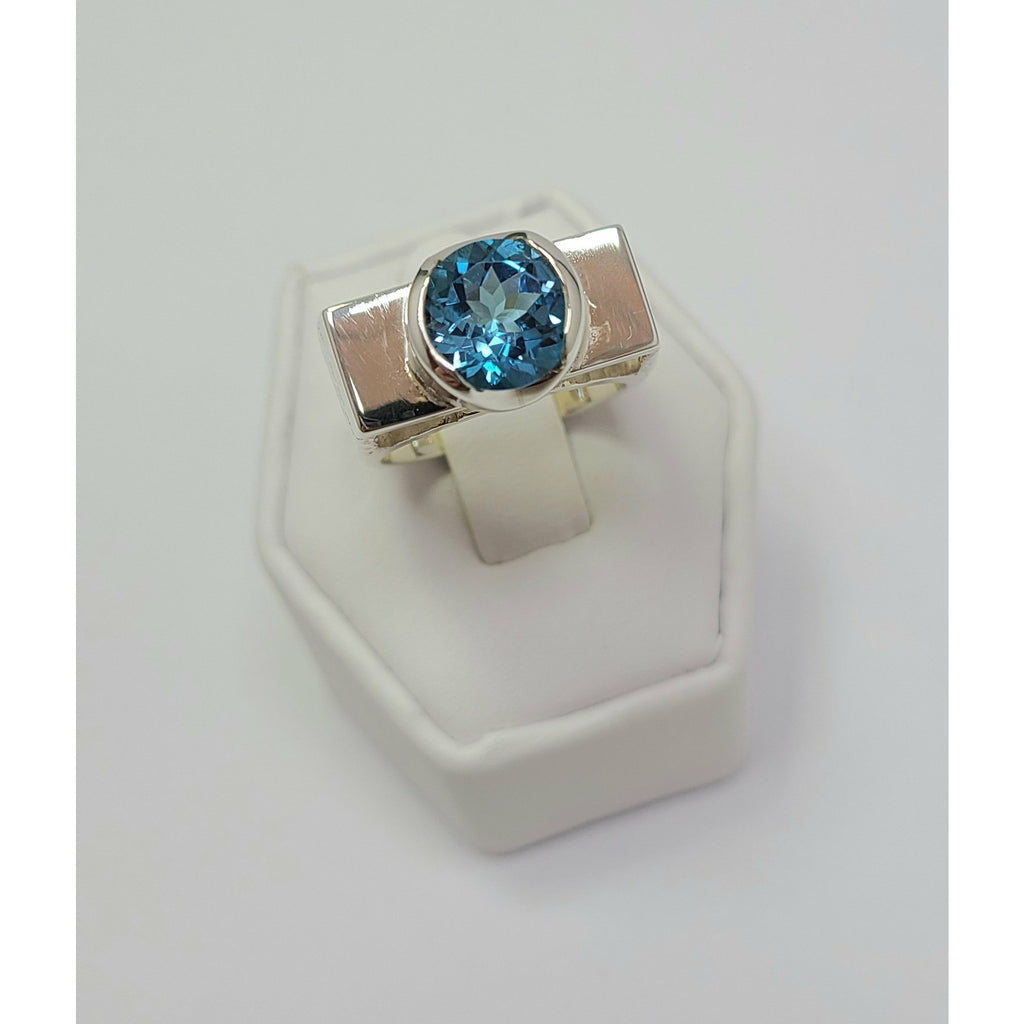 Blue Topaz sitting on high polish Ring