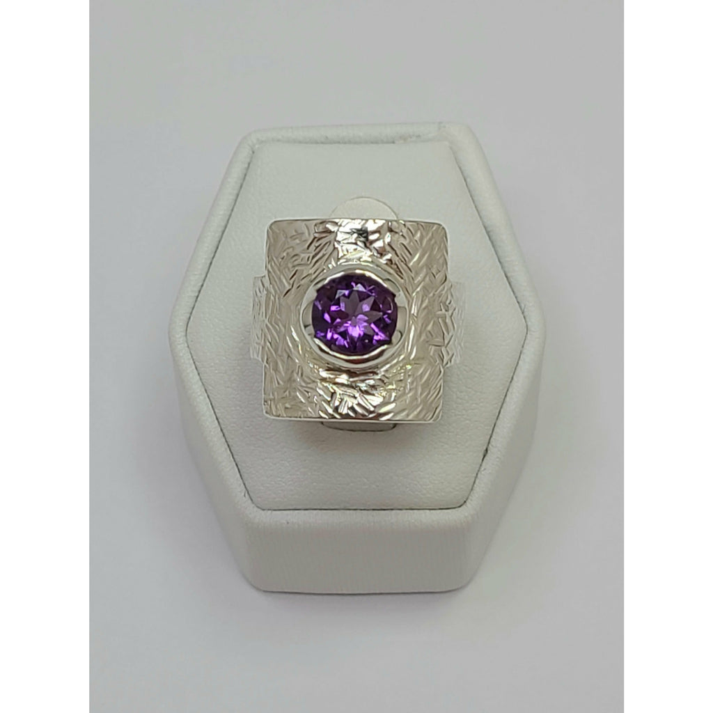 Amethyst sitting on mildly textured Sterling Silver Ring