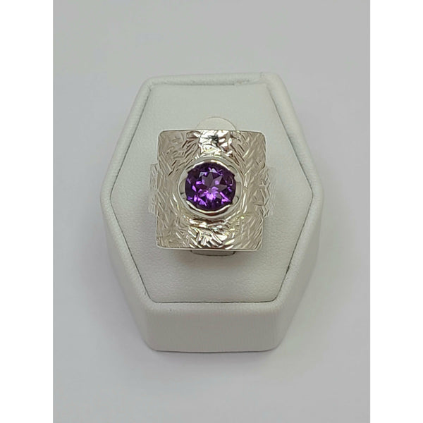 Amethyst sitting on mildly textured Sterling Silver Ring